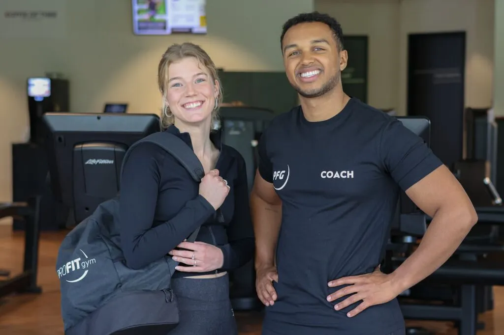 ProFit Gym Coach With Female Athlete And Gym Bag